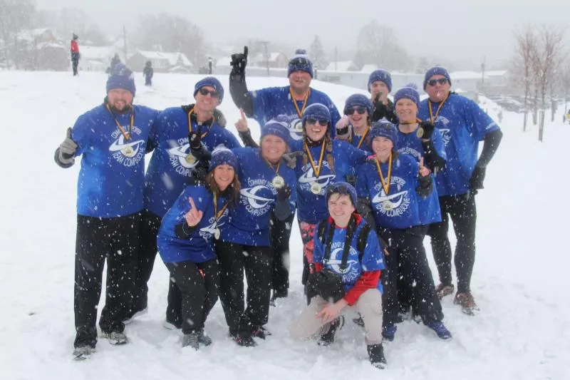 CSOLVE team members standing together in the snow after March Mudness for mental health