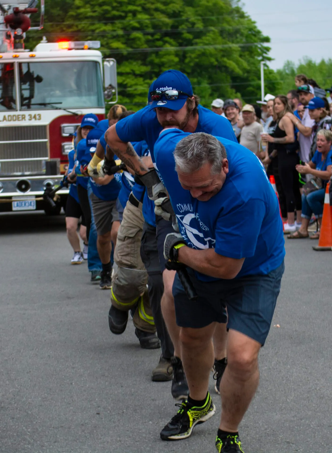 CSOLVE team members carrying a firefighter during a community challenge event