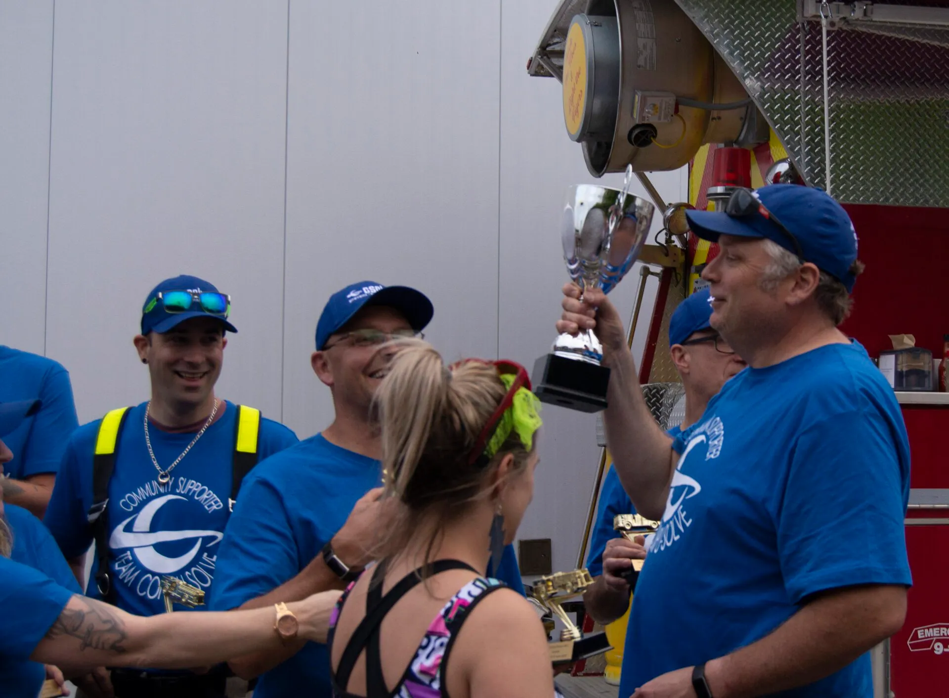CSOLVE team members smiling as one teammate holds up a trophy